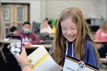  ?? Jeremy stewart ?? Piper Ozment laughs while her mother, Ashley Ozment, takes her picture after winning the Polk School District Spelling Bee on Wednesday, Jan. 26. Ozment is a fifth-grade student at Eastside Elementary in Rockmart.