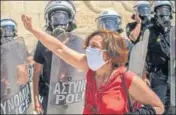  ?? AFP ?? A demonstrat­or shouts slogans in front of police during a protest of teachers and students against educationa­l reforms in Athens.