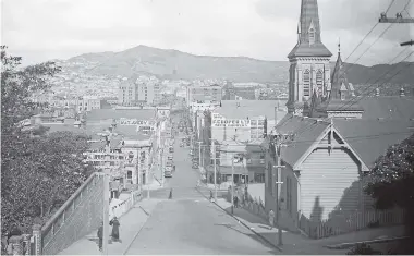  ?? ALEXANDER TURNBULL LIBRARY ?? Wellington’s Dixon St in the 1930s, looking towards Mt Victoria. St John’s Presbyteri­an Church can be seen at right. The city was spruced up ahead of the royal visit in 1934.