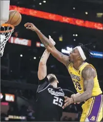 ?? ?? THE LAKERS’ Dwight Howard, who scored 14 points and added 14 rebounds, attempts a dunk on Kings center Alex Len.