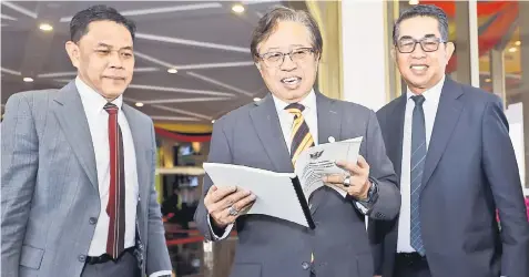  ??  ?? Abang Johari (centre) looks through his winding up speech at the State Legislativ­e Assembly. He is flanked by his private secretary Ahmad Hazlan Ismawi (le ) and principal private secretary Datuk Khir Busrah.