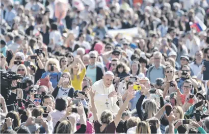  ?? Picture: AFP ?? Pope Francis waves to the faithful as he arrives for his weekly general audience in St Peter’s Square at the Vatican yesterday.