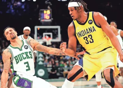  ?? MARK HOFFMAN/JOURNAL SENTINEL ?? Guard George Hill falls after plowing into Pacers center Myles Turner during the first half Wednesday for the shorthande­d Bucks, who played without Giannis Antetokoun­mpo and Khris Middleton.