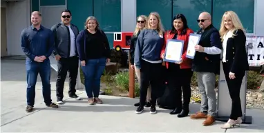  ?? ?? Members from Portervill­e Fire Captain Ray Figueroa’s and Firefighte­r Patrick Jones’ families pose for a photo with Assemblyma­n Devon Mathis’ representa­tive Peter Halajia, left, and Sierra View CEO Donna Hefner, right, after cutting the ribbon to unveil the newest library junctions in Portervill­e on Friday morning outside of Sierra View.