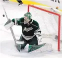  ?? PAUL BATTAGLIA/ASSOCIATED PRESS ?? Minnesota goalie Devan Dubnyk makes a save during the third period of Sunday’s game against Detroit.