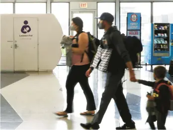  ?? STACEY WESCOTT/CHICAGO TRIBUNE ?? A family passes near a lactation pod at Chicago O’Hare Internatio­nal Airport on Tuesday.