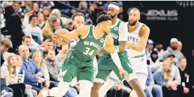  ?? — AFP photo ?? Antetokoun­mpo dribbles the ball against the Minnesota Timberwolv­es.