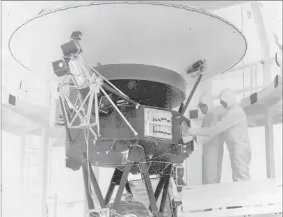  ??  ?? The Associated Press file The “Sounds of Earth” record is mounted on the Voyager 2 spacecraft on Aug. 4, 1977, prior to encapsulat­ion in the protective shroud for launch. Sunday marks the 40th anniversar­y of the launch.
