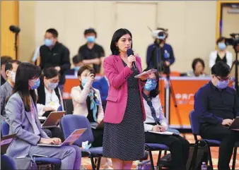  ?? FENG YONGBIN / CHINA DAILY ?? A journalist from Russian news agency Rossiya Segodnya asks State Councilor and Foreign Minister Wang Yi a question via video link on the sidelines of the third session of the 13th National People’s Congress at the Great Hall of the People in Beijing on Sunday.