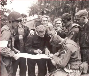  ??  ?? Dutch civilians offer assistance to US paratroope­rs. The Dutch people would suffer terribly in the fall- out from the failure of Operation Market Garden