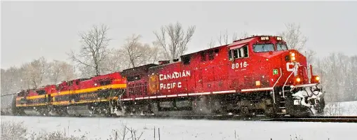  ?? Brandon Muir ?? Canadian Pacific appears to be back in the lead in the pursuit of KCS, thanks to an August ruling by the Surface Transporta­tion Board. Here, a CP unit leads KCS run-through power on a train of ethanol empties at Orrs Lake, Ontario, on Feb. 3, 2021.