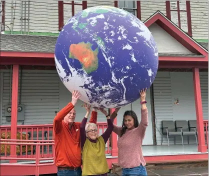  ?? RICK REMSNYDER — DAILY FREEMAN ?? Town of Shandaken Conservati­on Advisory Council members, from left: Bruce Barry, Beth Waterman and Maya Lilly hold up a giant inflatable earth in front of the Phoenicia Playhouse. The council is sponsoring Earth Day activities on Sunday, April 21, 2024, during the farmers market at the Pine Hill Community Center from 11a.m. to 2p.m. A climate film series will continue from 3to 5p.m. at the Phoenicia Playhouse.