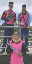  ?? JULIA MCKAY ?? Jonathan Corbett, Sarah Sadavoy and Kiana Damavandi are members of Team Bayridge ambassador­s from Queen's University handing out eclipse glasses and answering questions from those gathered at Bayridge Secondary School on Monday.