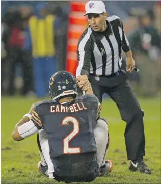  ?? JONATHAN DANIEL/ GETTY IMAGES ?? Quarterbac­k Jason Campbell of the Chicago Bears gets a hand up from referee Gene Steratore after being decked during last Sunday’s game against the Houston Texans at Soldier Field.
