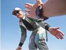  ?? THE ASSOCIATED PRESS FILE PHOTO ?? Dale Earnhardt Jr. reaches to fans during driver intros before the NASCAR Series Cup race at Texas Motor Speedway in Fort Worth, Texas, on Nov. 5.