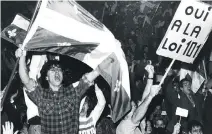  ?? PETER ANDREWS ?? Philippe Beauchamp of Longueuil waves the Quebec flag during an emotional rally in defence of Bill 101 at Paul Sauve Arena in 1988. Quebec’s language laws have been a frequent point of contention over the years.