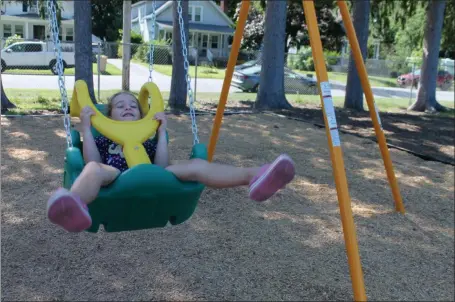  ?? PHOTOS BY LAUREN HALLIGAN — MEDIANEWS GROUP ?? Four-year-old Matilda Matthews of Saratoga Springs smiles while using one of the new Zero-G chair swings at East Side Rec Playground.