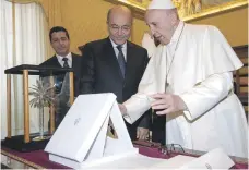  ?? EPA ?? Pope Francis exchanges gifts with the President of Iraq, Barham Salih, at the Vatican in Rome yesterday