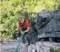  ?? MICHAEL VIRTANEN/ASSOCIATED PRESS FILE PHOTO ?? Phil Brown rappels down from Old Man’s Route on the west face of Seneca Rocks last month in West Virginia. The crag has no hiking trail to the top so climbers have to either rappel or climb down.