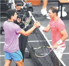  ?? — AFP file photo ?? Carlos Alcaraz and Nadal shake hands after the match at The Netflix Slam at Michelob ULTRA Arena in Las Vegas, Nevada.