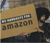  ?? Drew Angerer / Getty Images ?? Activists and community members celebrate Thursday after opposing Amazon’s plan to move into Queens.