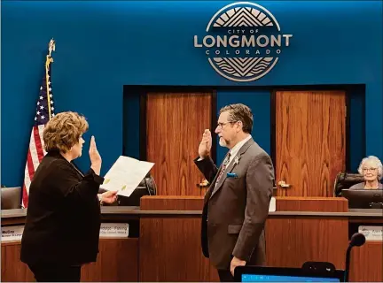  ?? MATT BENNETT — STAFF WRITER ?? Longmont City Clerk Dawn Quintana administer­s the oath of office to at-large City Councilman Sean Mccoy during Tuesday’s regular council meeting. Mayor Joan Peck looks on in the background.