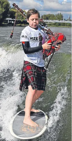  ??  ?? Dollar Academy pupil Max Rae played Scotland the Brave as he surfed the waves.