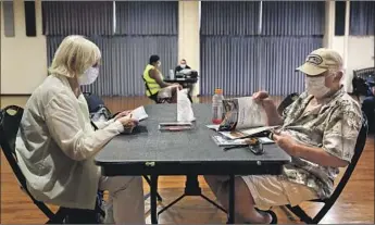  ?? Christina House Los Angeles Times ?? OFFICIALS and activists speculated that the small number of centers spread across L.A. made them inaccessib­le. Above, Rita Zeid, left, and her husband, Mike, at a cooling center in Seal Beach on Sept. 6.