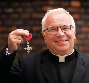  ?? Victoria Jones ?? The Very Reverend Dr David Hoyle with his MBE medal for services to faith and to vulnerable communitie­s in Bristol. Above left, receiving the award