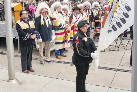  ?? GAVIN YOUNG ?? Calgary Mayor Naheed Nenshi and Treaty 7 Chiefs watch the raising of the Treaty 7 flag at City Hall on Thursday. Nenshi said the flag-raising “is a small gesture — but gestures matter.”