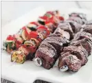  ?? CARL TREMBLAY THE ASSOCIATED PRESS ?? The beef is paired with a trio of firm and flavourful vegetables that come into their own when grilled: peppers, red onions and zucchini.