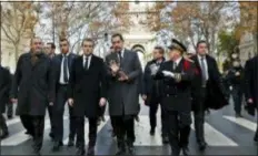  ?? THIBAULT CAMUS — THE ASSOCIATED PRESS ?? France’s President Emmanuel Macron, centre left, France’s Interior Minister Christophe Castaner, center, Secretary of State to the Interior Minister Laurent Nunez, left, and Paris police Prefect Michel Delpuech, right, arrive to visit firefighte­rs and riot police officers the day after a demonstrat­ion, in Paris, Sunday.