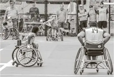  ??  ?? The Houston Hotwheels congratula­te each other on a great season after being runnersup in the Junior Wheelchair Softball World Series.