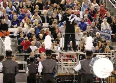  ?? JONATHAN TRESSLER— THE NEWS-HERALD ?? Willoughby South High School Marching Band’s Senior Drum Major — at center, on stand — Joe Frate, does his thing during the band’s final number at the Lake County Music Educators Associatio­n 2018 Marching Band Festival at the Mentor Schools’ Jerome T. Osborne Stadium Sept. 26.