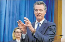  ?? Rich Pedroncell­i The Associated Press ?? Gov. Gavin Newsom signed a law last week that requires presidenti­al candidates to provide five years of income tax returns. Four voters have sued to block the law.