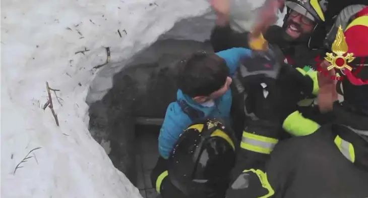  ??  ?? RIGOPIANO, Italy: This frame from video shows Italian firefighte­rs extracting a child alive yesterday from under snow and debris of an hotel that was hit by an avalanche on Wednesday. — AP