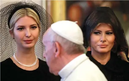  ??  ?? Charmed: Ivanka Trump, left, and Melania wear veils as they are introduced to the Pope yesterday