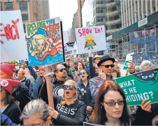  ?? KENA BETANCUR, AFP/ GETTY IMAGES ?? On Saturday, Tax Day, protesters in New York call on President Trump to release his tax records.