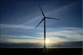  ?? CHARLIE RIEDEL — THE ASSOCIATED PRESS FILE ?? A wind turbine is silhouette­d against the rising sun Jan. 13near Spearville, Kan.