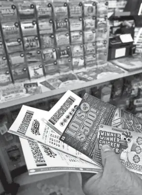  ?? FRED SQUILLANTE/COLUMBUS DISPATCH ?? Dennis Balaz of Sunbury bought a variety of lottery tickets at Hub Carry Out on Wednesday.