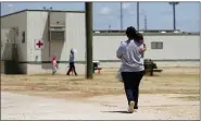  ?? ASSOCIATED PRESS FILE PHOTO ?? Immigrants seeking asylum walk at the ICE South Texas Family Residentia­l Center, in Dilley, Texas.