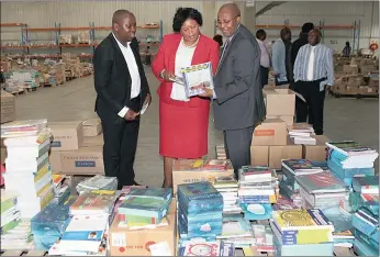  ?? PICTURE: MARILYN BERNARD ?? KZN Education MEC Peggy Nkonyeni, Ndabase Printing Solutions chief executive Thanda Nyide, left, and department head Nkosinathi Sishi inspect textbooks and stationery to be delivered to schools by next Friday.