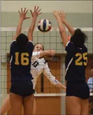  ??  ?? Boyertown’s Emma Ludwig (13) hits through Pope John Paul II blockers Mikaela Monroe (16) and Chelsea Harvey (25).