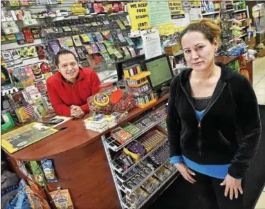  ?? CATHERINE AVALONE — NEW HAVEN REGISTER ?? Marcia Chacon, owner of My Country Store at 677 Main St. in East Haven, and her son, Paul Matute. Chacon emigrated from Ecuador and has operated the Latino market for since 1999.