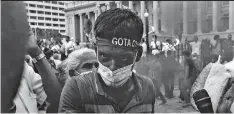  ?? ?? EYES OF RAGE: Protestor at Tuesday’s rally stares in anger over country’s mass shortages (Photograph­s by Tavish Gunasena)