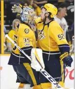  ?? Associated Press photo ?? Nashville Predators centre Ryan Johansen (92) congratula­tes goalie Pekka Rinne (35), of Finland, after they defeated the St. Louis Blues in Game 3 of a second-round NHL hockey playoff series Sunday in Nashville, Tenn.