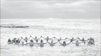  ?? ?? A group consisting mostly of women, who call themselves "The Endorphins", gather for a sunrise swim in the chilly waters of Lake Ontario during freezing temperatur­es in Toronto, Ontario, Canada January 17, 2024. (Reuters photo)