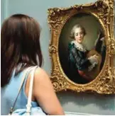  ??  ?? A visitor looks at Francois Hubert Drouais's "Portrait of Carlos Fernando FitzJames-Stuart, Marquess of Jamaica," long considered a portrait of Madame du Barry in costume.