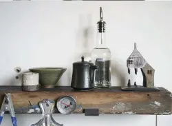  ??  ?? Above One of Yukihiro’s finished houses, the slightly uncanny looking Ruin House, takes pride of place on his kitchen shelf.