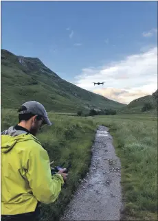  ??  ?? A member of Lochaber Mountain Rescue Team pilots a drone.